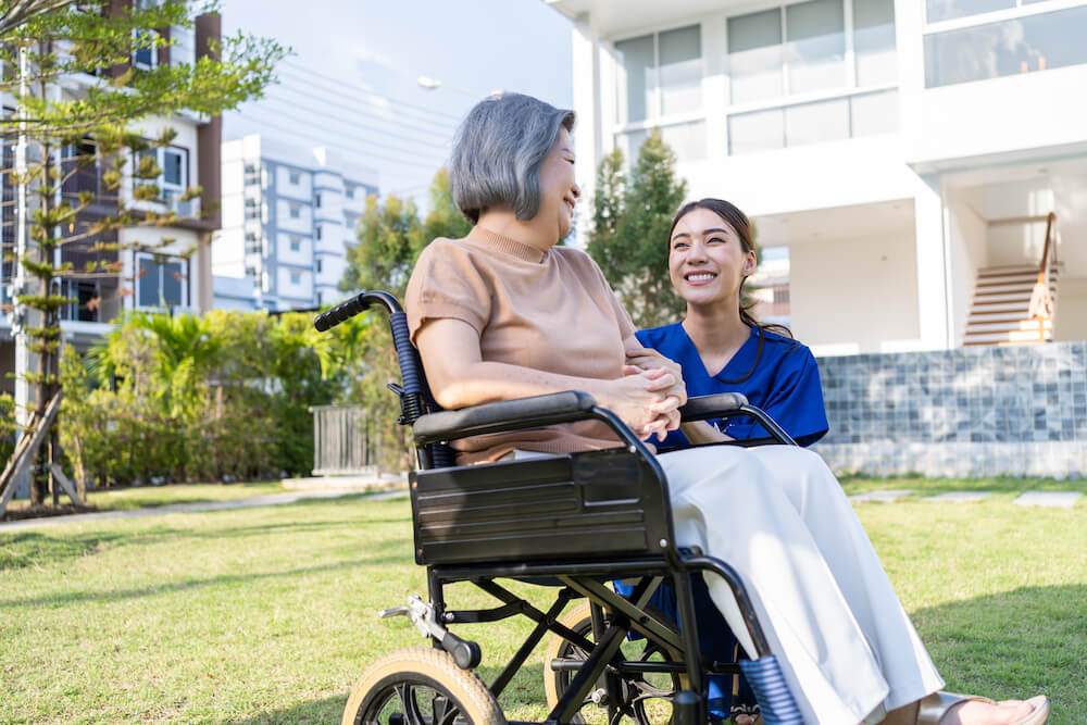 happy senior woman patient sitting in wheelchair